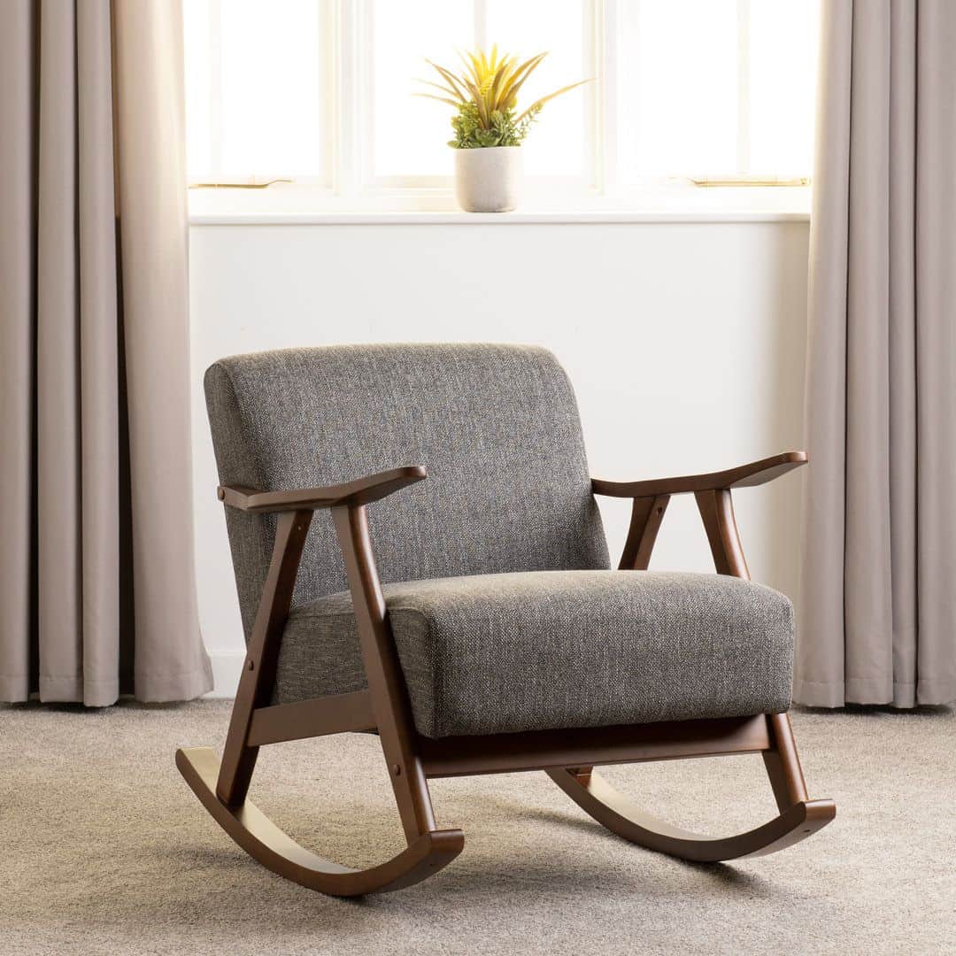A wooden rocking chair with upholstered seating and backrest. The chair features curved wooden armre… — 3D model