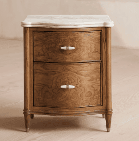 A classic nightstand with a marble top and two drawers. The wooden body features a rich, warm wood grain, and the drawers are complemented by light-colored, possibly ceramic or stone, drawer pulls. The legs are slender and taper downwards, terminating in metallic ferrules. — 3D model