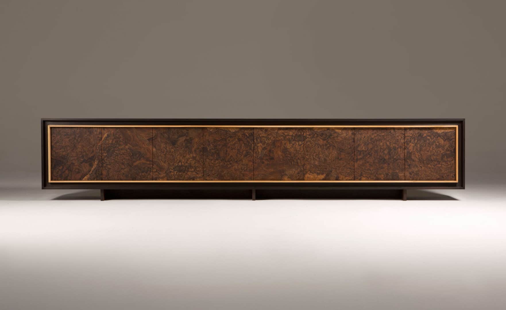 A long, low credenza with a dark frame and a distinctive burl wood veneer on its six cabinet doors.… — free BLEND 3D model