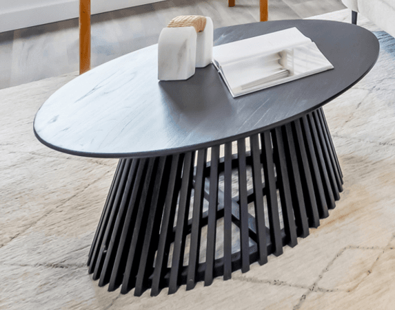 A modern black oval coffee table featuring a sculptural base composed of numerous vertically oriented slats forming a tapered, conical shape, supporting a smooth oval tabletop. — 3D model