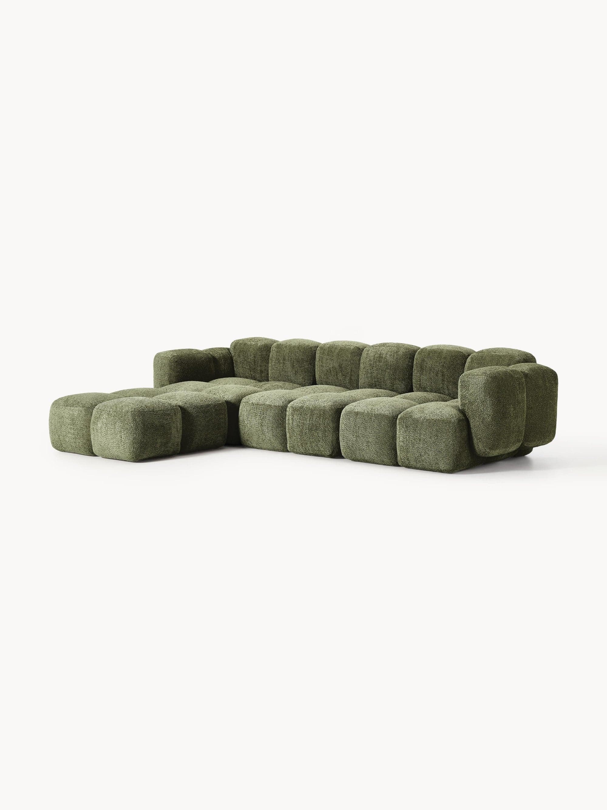 A modular sectional sofa with a unique, segmented design. Each segment is a rounded rectangular prism that creates a pixelated or pixel-like aesthetic. The sofa features a low profile and a generous depth, with a chaise lounge section on the left. The upholstery appears to be a textured fabric. — 3D model