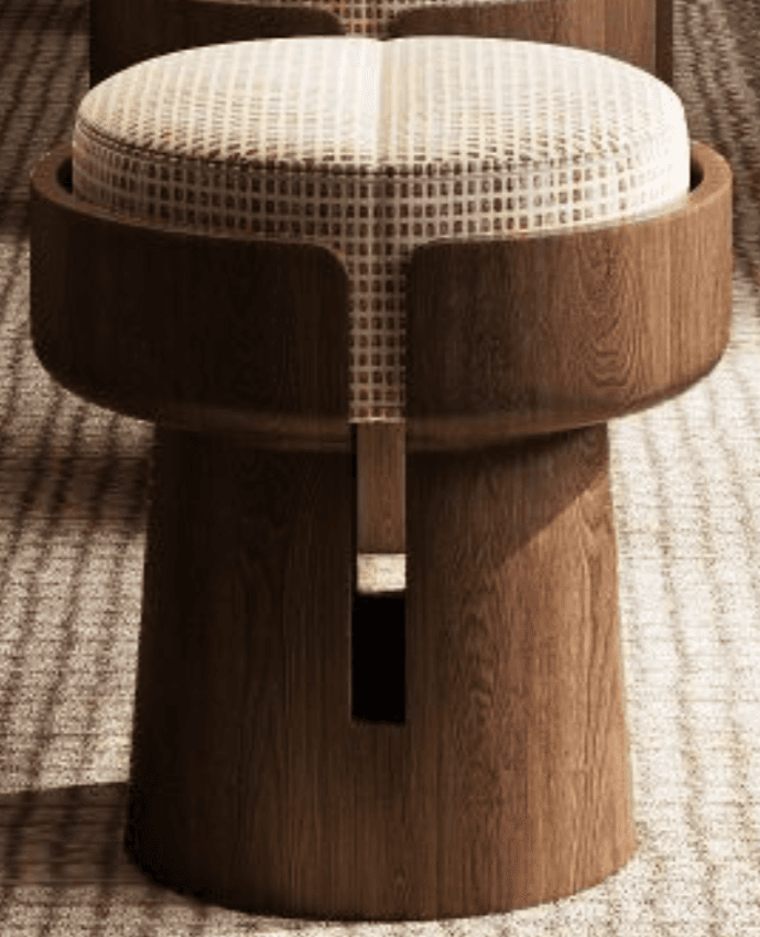 A contemporary stool featuring a cylindrical wooden base with a flared top section. The base has a cut-out detail on one side, revealing an internal wooden element. The seat is round and upholstered with a light-colored fabric featuring a subtle checkered pattern. The overall design is modern and sculptural. — 3D model