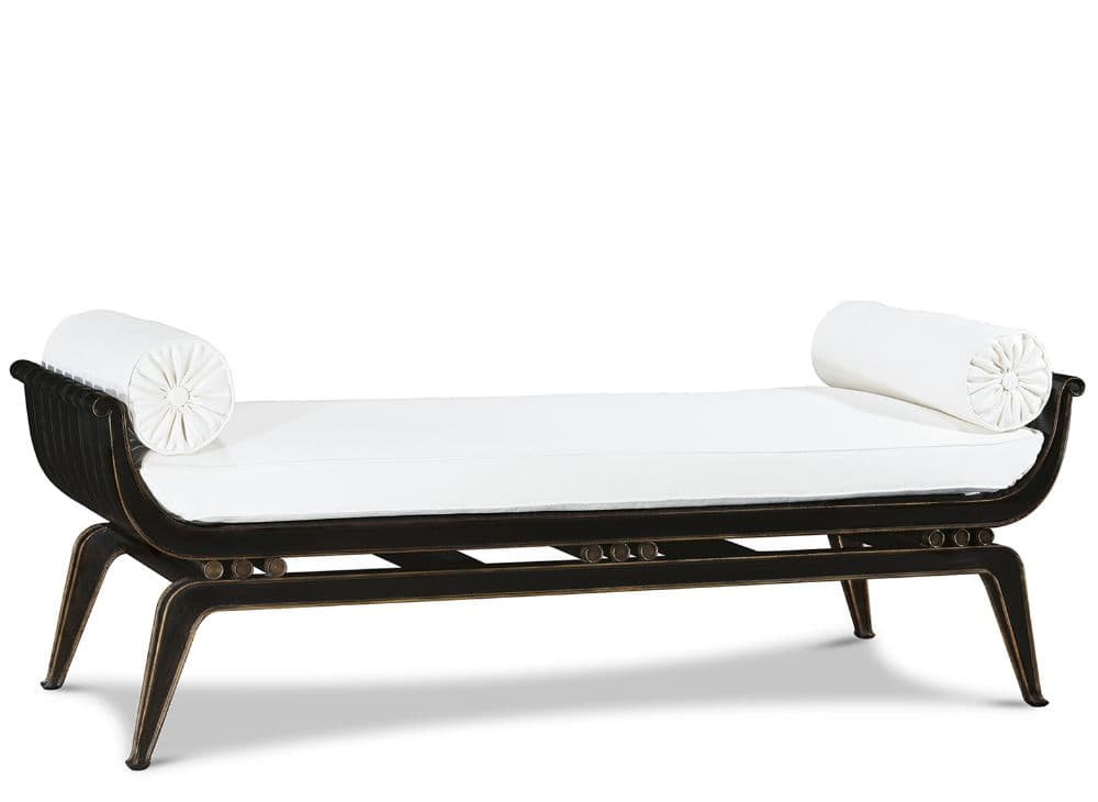 A neoclassical style daybed bench featuring a dark, distressed wooden frame with scrolled ends and splayed, tapered legs. It is topped with a rectangular white upholstered cushion and includes two matching white cylindrical bolster pillows at each end. The frame exhibits a worn, antiqued finish, possibly dark bronze or black with gold undertones. — 3D model