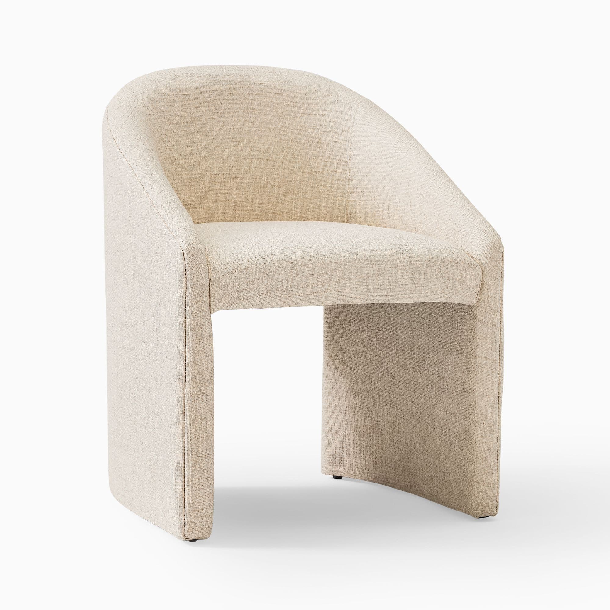 A compact, contemporary barrel-back accent chair, fully upholstered in a light beige or cream textured fabric, featuring a continuous curved backrest that integrates into armrests, and a solid plinth-style base. — 3D model
