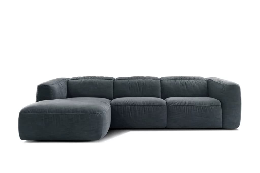 A sectional sofa with a chaise lounge attachment. The sofa features deep seating with plush, overstuffed cushions on both the seat and back. The arms are wide and integrated into the structure of the sofa. The overall design is modern and emphasizes comfort. The chaise is positioned on the left side of the sofa when viewed from the front. — 3D model