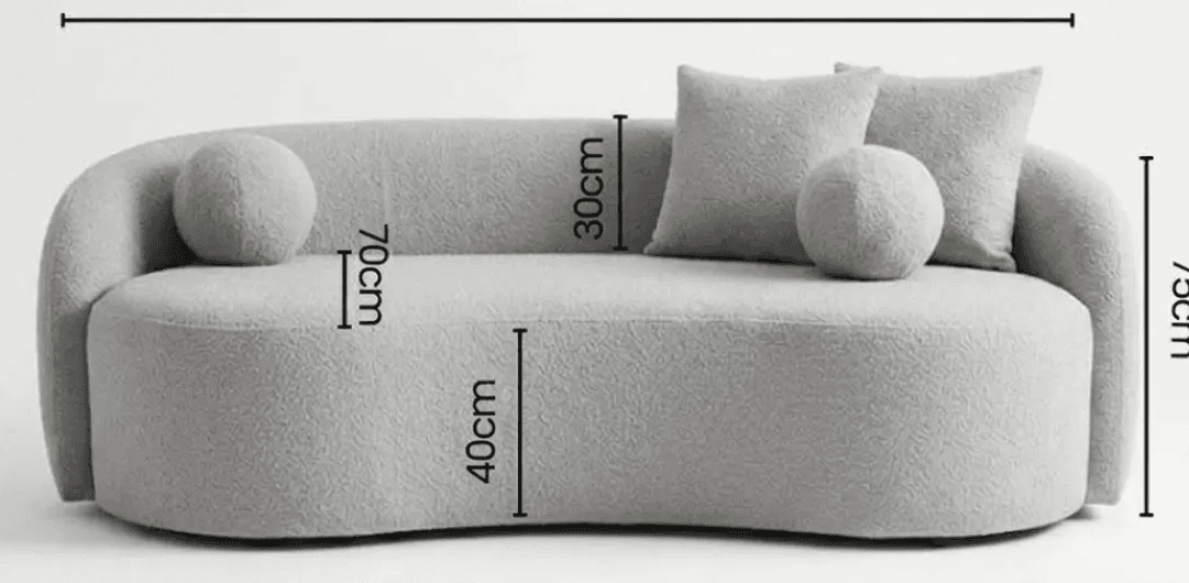 A contemporary, light gray boucle upholstered chaise lounge featuring a distinctive serpentine, curved silhouette. It has an integrated backrest and armrest on one side, flowing seamlessly into the base. The chaise comes with three matching boucle cushions: two square throw pillows and one spherical pillow, enhancing its soft and inviting aesthetic. — 3D model