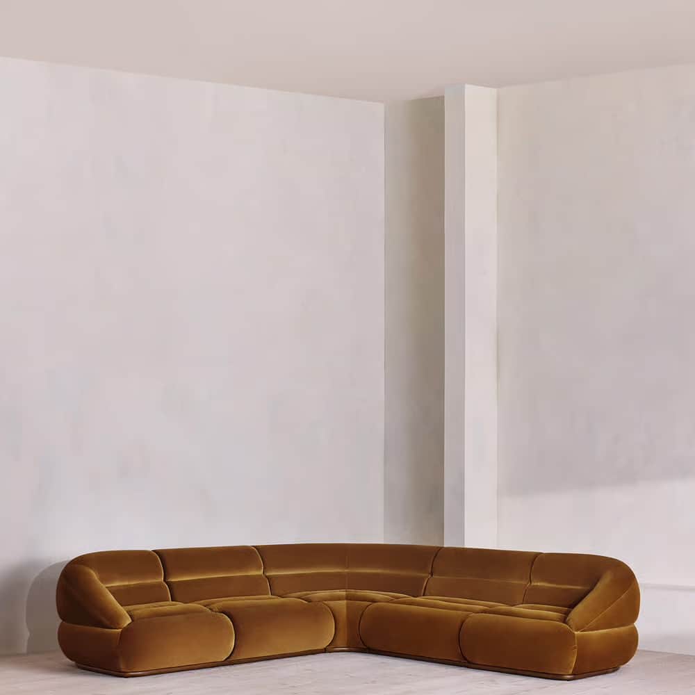 A modular sectional sofa with rounded edges and a plush velvet upholstery. The sofa is configured in… — 3D model
