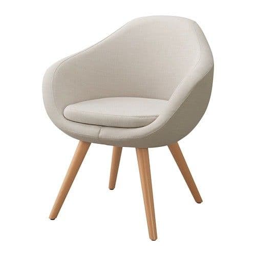 A contemporary accent chair featuring a rounded, tub-style upholstered seat and backrest, supported by four splayed wooden legs. The upholstery is a light beige or cream-colored fabric, and the chair includes a removable seat cushion. — 3D model