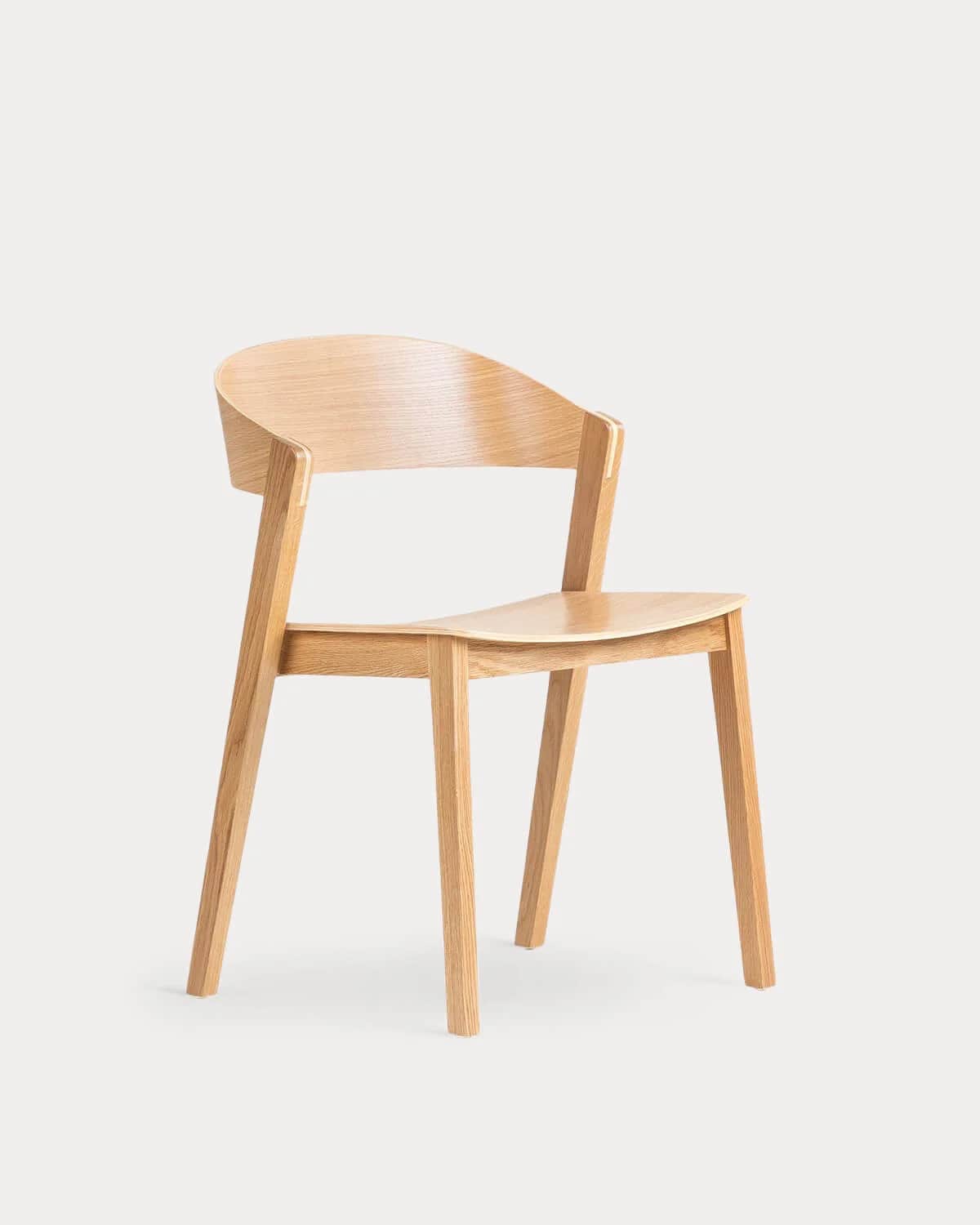A light-toned wooden armchair featuring a curved backrest and integrated armrests. The seat is gentl… — free BLEND 3D model