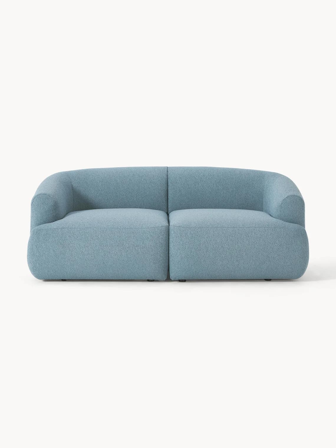 A light blue upholstered sofa with a curved back and armrests. The sofa appears to be modular, with two distinct seating sections. It sits on low, dark legs. — 3D model