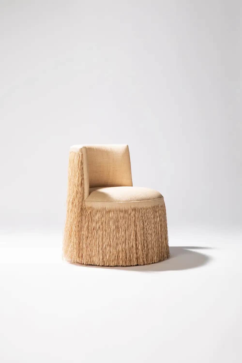 An armless accent chair featuring a distinctive design with a fully fringed base and lower back, uph… — 3D model