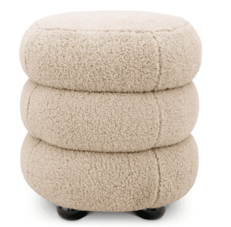 A light beige, plush ottoman featuring a unique stacked design composed of three rounded, tiered seg… — 3D model