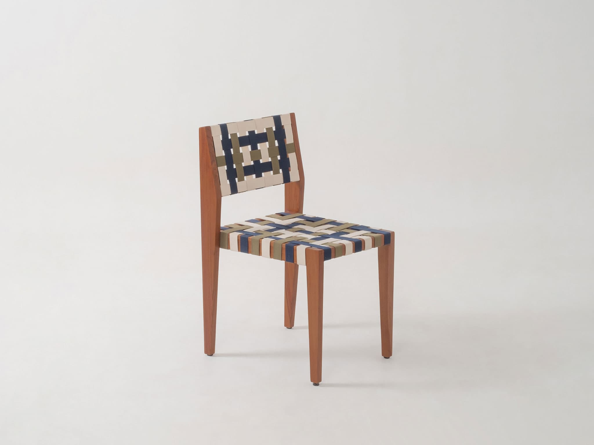 A side chair with a wooden frame and a woven seat and backrest. The frame consists of four tapered legs and a minimalist back support. The seat and backrest are constructed from a woven pattern of fabric straps in cream, navy blue, and olive green. — 3D model