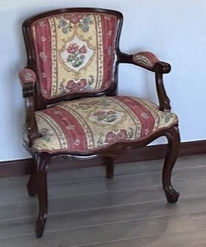 A single Rococo Revival style armchair featuring a dark, carved wooden frame and elaborate floral upholstery. — 3D model