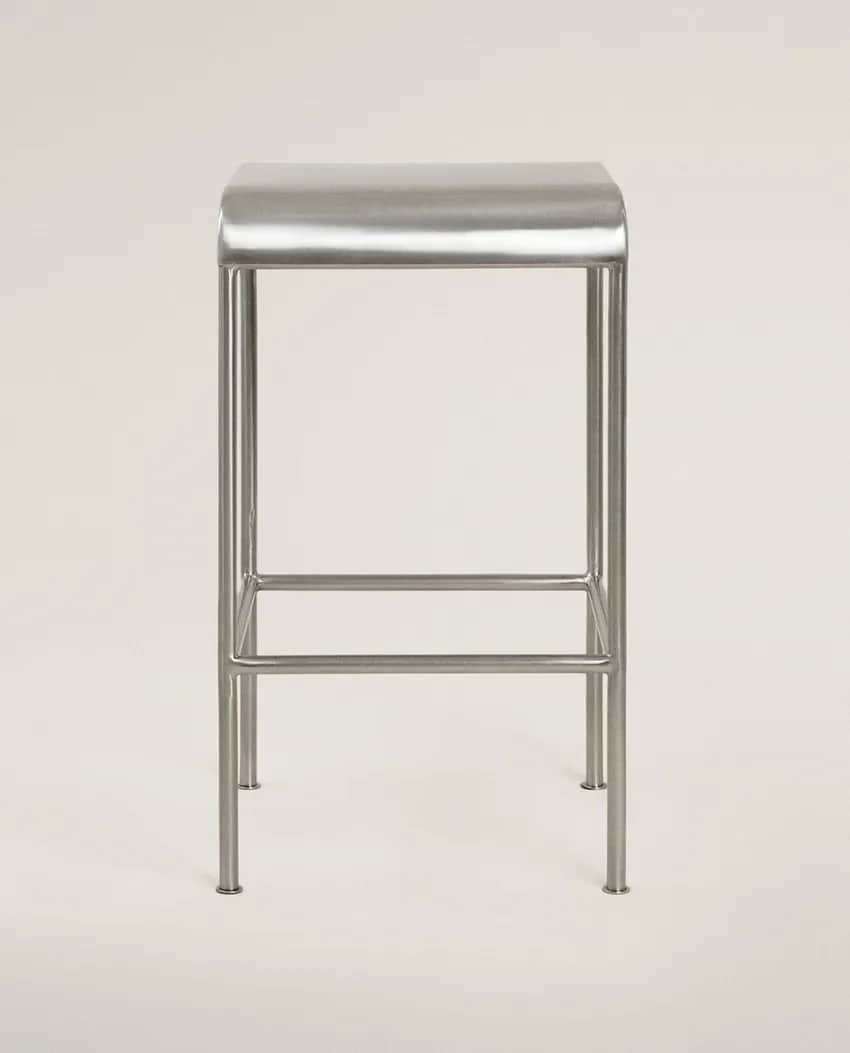 A minimalist, contemporary bar stool constructed from brushed metal, featuring a rectangular seat wi… — 3D model