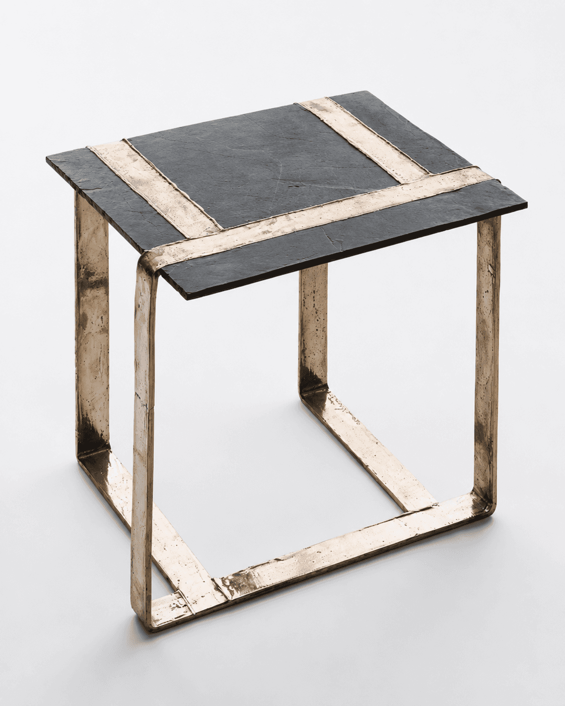 A square side table featuring a dark, textured slate top and a robust, open-cube base constructed fr… — 3D model