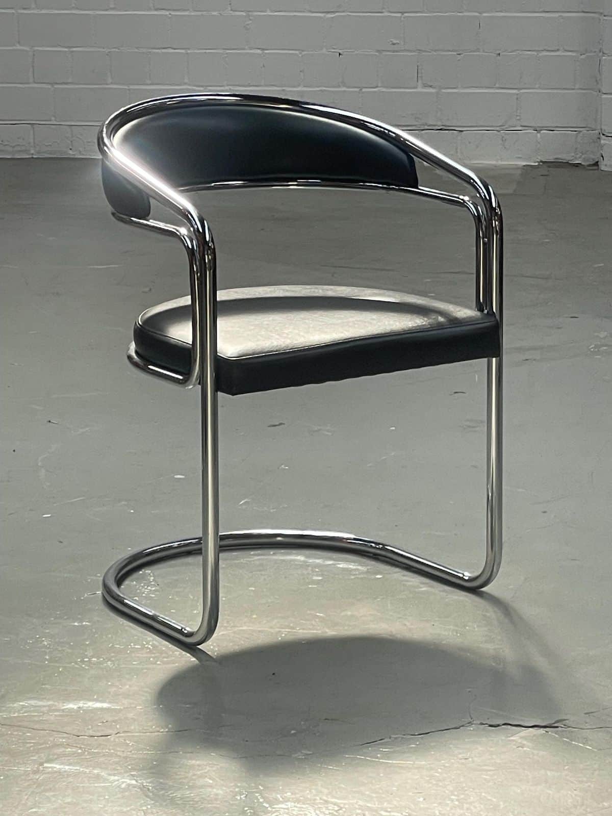 A modern armchair with a tubular metal frame and upholstered seat and backrest. The frame has a chro… — free OBJ 3D model