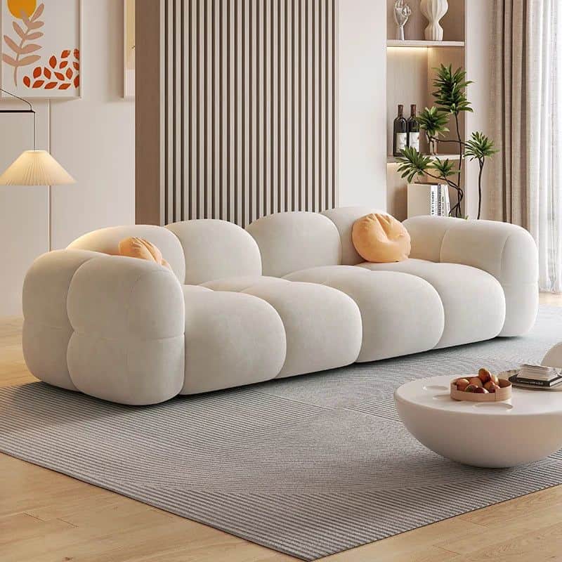 A long, contemporary, off-white modular sofa featuring a distinctive bubbly design with rounded, bul… — 3D model