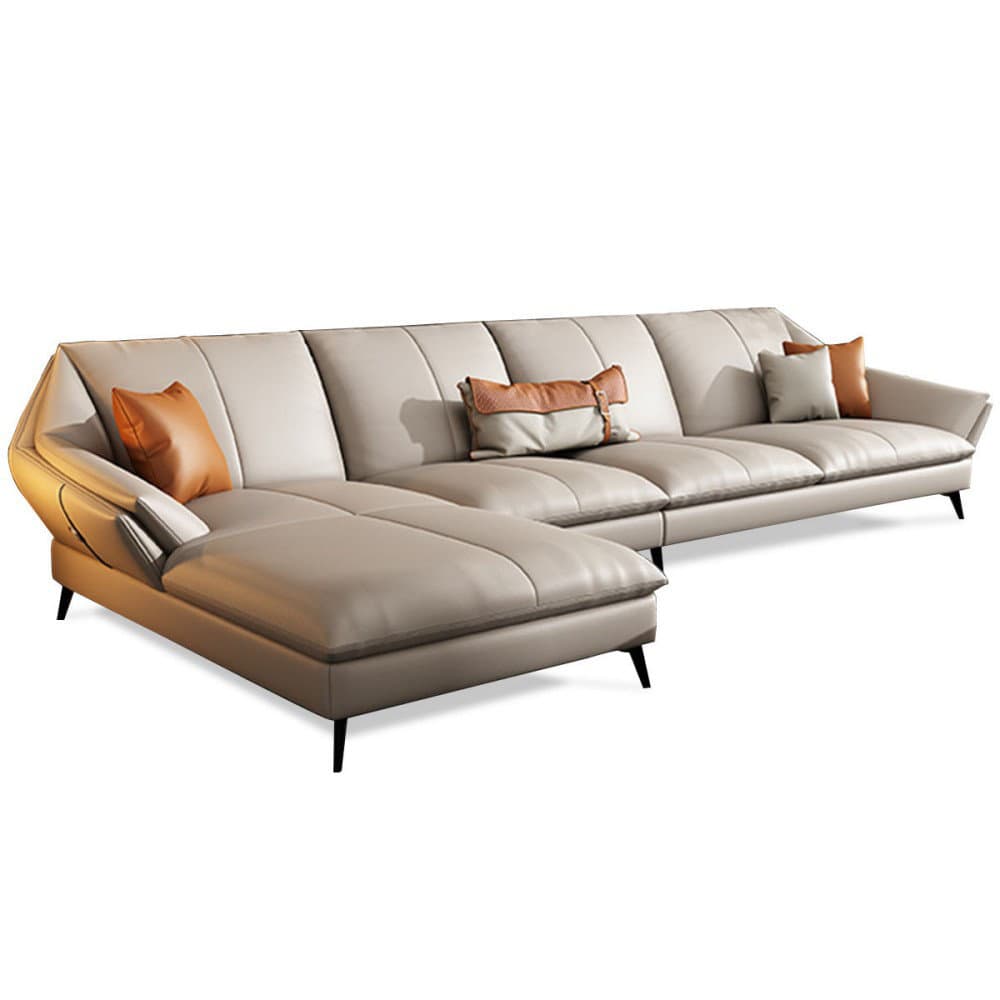 A modern sectional sofa with a chaise lounge. The sofa features multiple seating sections and is upholstered in a light-colored material, likely leather or a high-quality synthetic. It includes several accent pillows, two of which are a contrasting orange-brown color, and one is a patterned pillow with cream and orange hues. The sofa has a low profile with thin, metal legs. The backrests and seat cushions are segmented with stitching details, contributing to a contemporary aesthetic. — 3D model