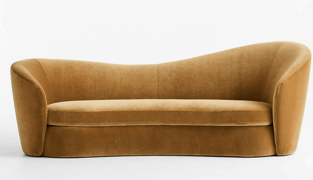 A contemporary sofa upholstered in a rich golden brown velvet. It features an distinctive organic, undulating backrest that swoops down in the middle, and gently curved, integrated arms. The design is fluid and lacks traditional legs, with the base appearing slightly recessed or solid to the floor. The single seat cushion is well-defined, and the overall form suggests a modern, sculptural aesthetic. — 3D model