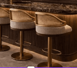 A sophisticated swivel bar stool featuring a brass-finished metal frame and disc base, a woven cane… — 3D model