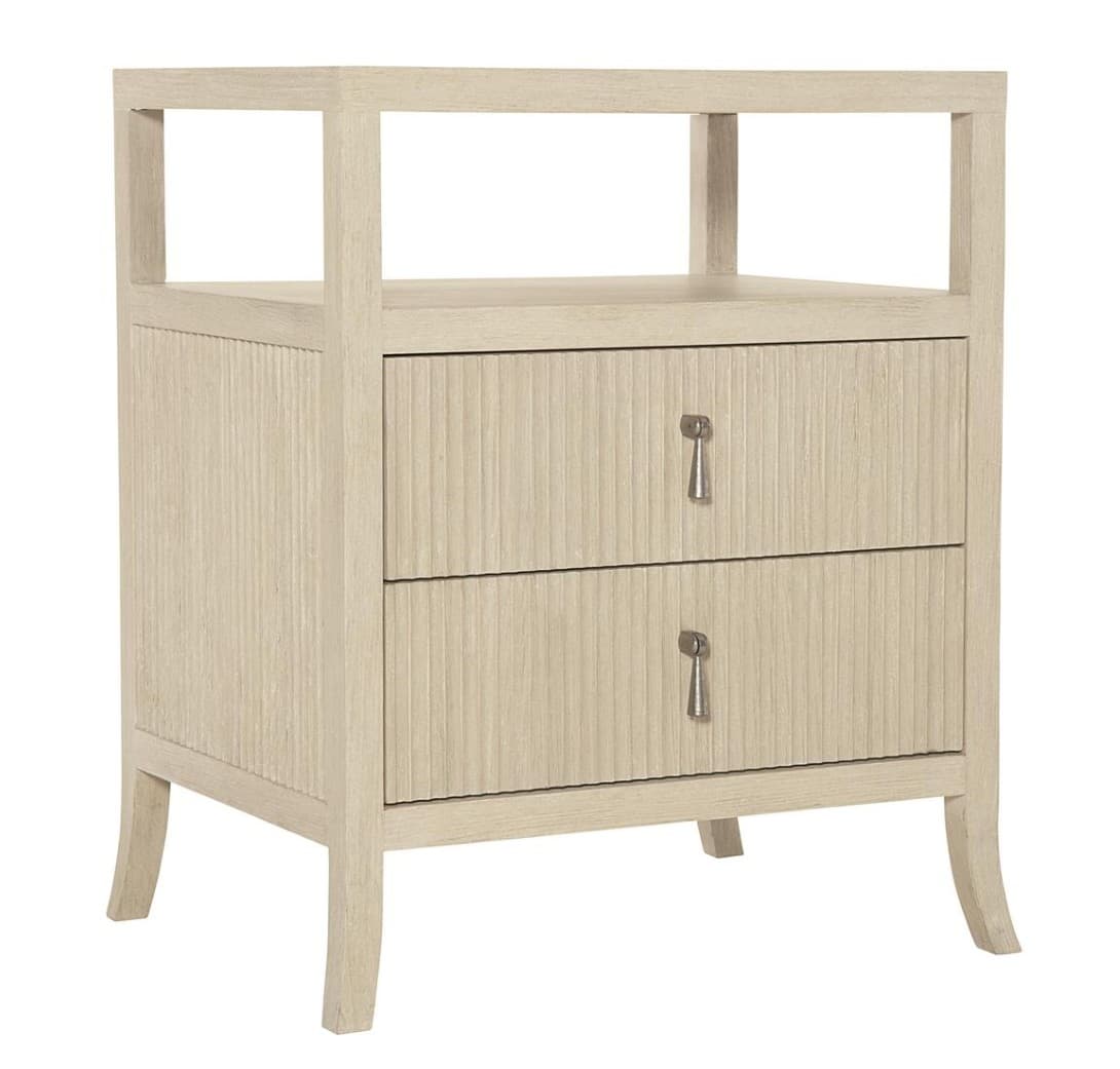 A light-colored wooden nightstand featuring two drawers with prominent reeded texture on their fronts, and an open top compartment. It has four gently tapered legs and decorative, irregularly shaped silver-tone drawer pulls. The overall finish is a light, natural wood tone with visible grain. — 3D model