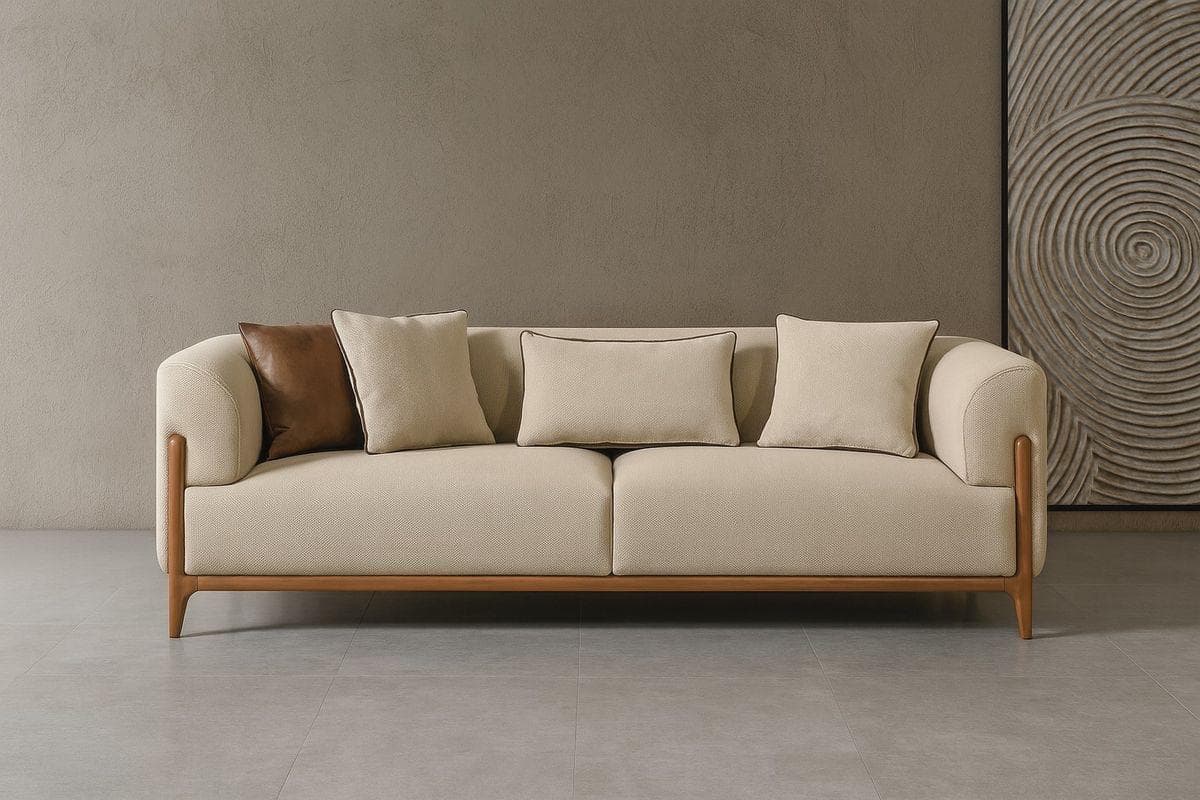 A modern three-seater sofa featuring a light beige fabric upholstery and a distinctive exposed wood frame. The sofa has rounded armrests, two large seat cushions, and three loose back cushions, along with two accent pillows, one of which is brown. — 3D model