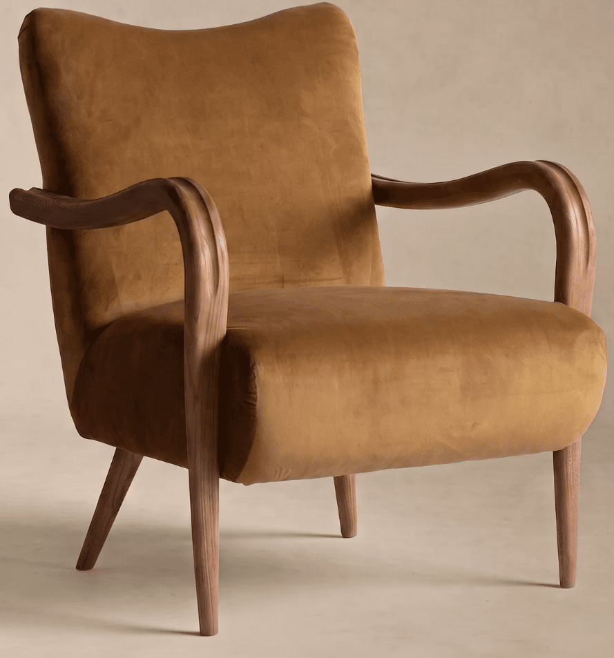 A single-seater lounge chair featuring golden-brown velvet upholstery and an exposed wooden frame, including curved armrests and tapered legs. — 3D model