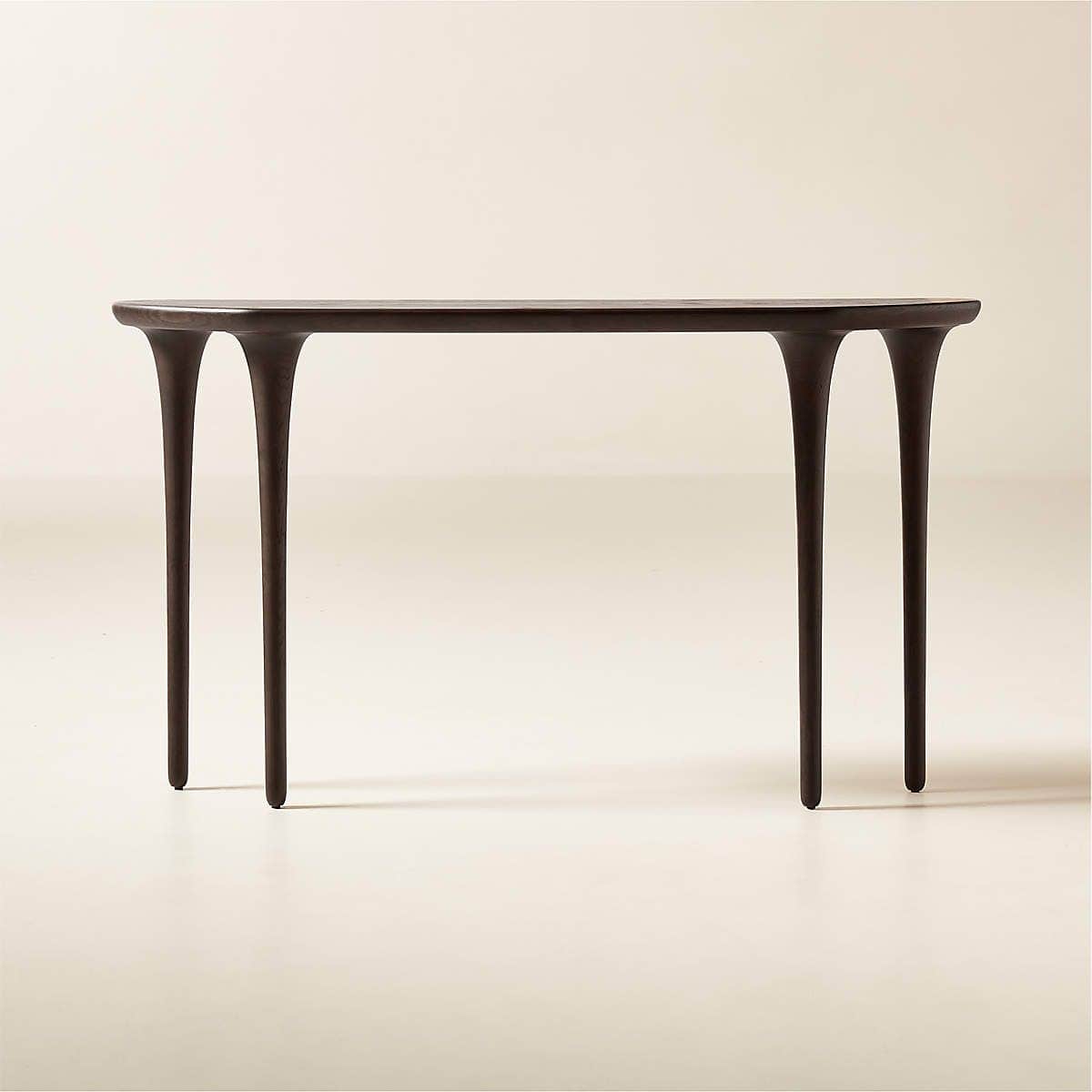 A dark-toned console table featuring a subtly curved rectangular top and four distinctive, sculptura… — 3D model