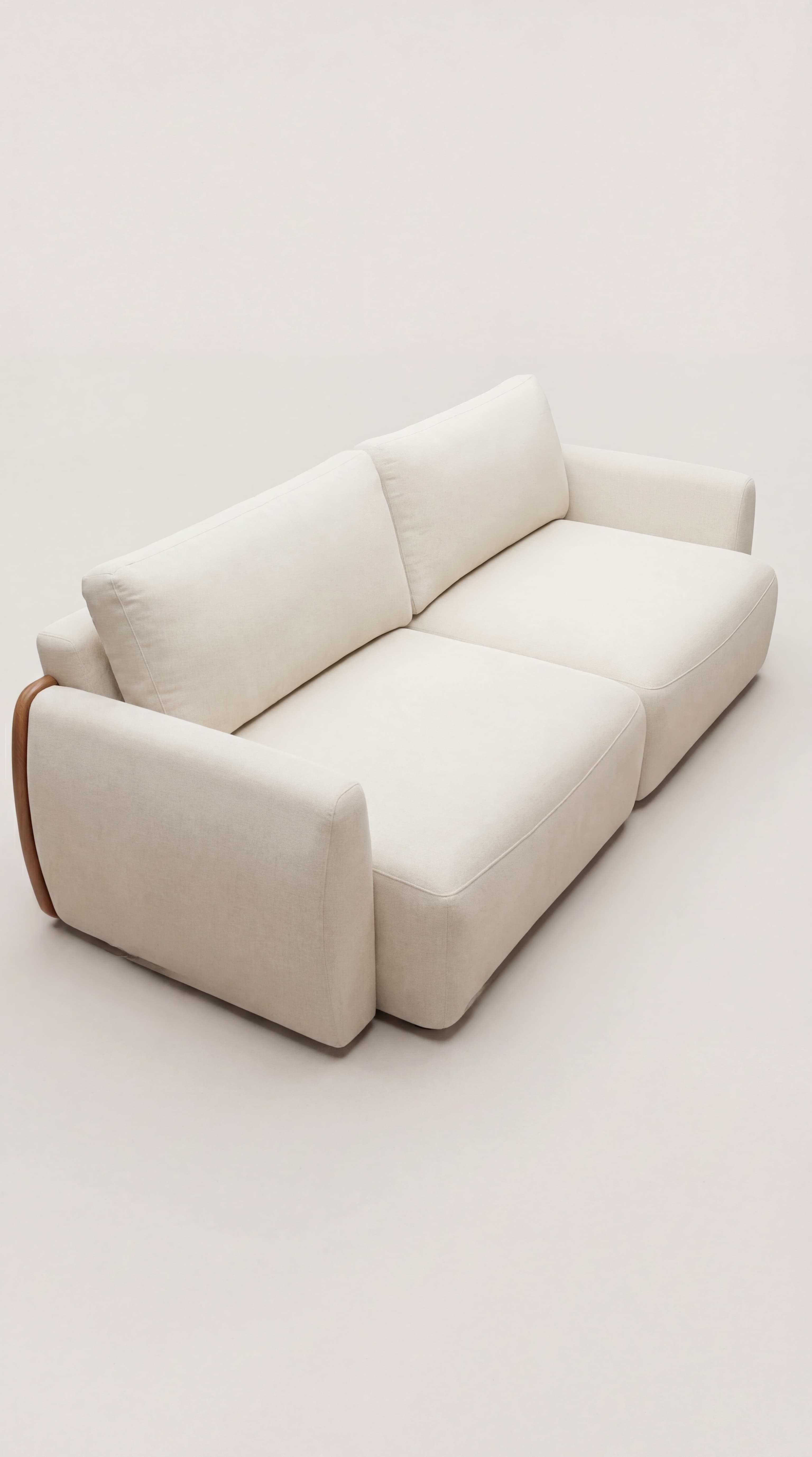 A contemporary two-seater sofa upholstered in a light, cream-colored fabric. The design features soft, rounded lines for the armrests and plump, individual seat and back cushions. A distinctive design element is the curved, dark wood paneling integrated into the outer sides of the armrests, providing a subtle contrast to the light upholstery. — 3D model
