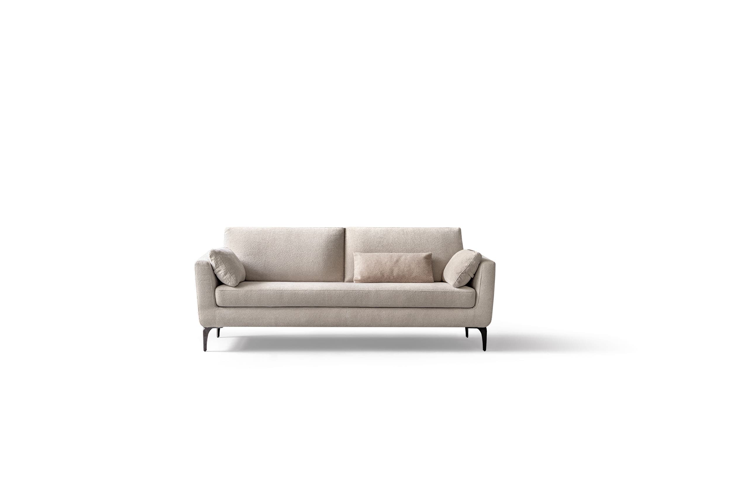 A modern, upholstered sofa with a rectangular silhouette. It features a two-cushion seat and a supportive backrest divided into two sections. Two throw pillows are placed on the sofa: one rectangular lumbar pillow in the center and a smaller square pillow tucked into the left armrest. The sofa is supported by slender, dark-colored legs with a curved, angled design. — 3D model
