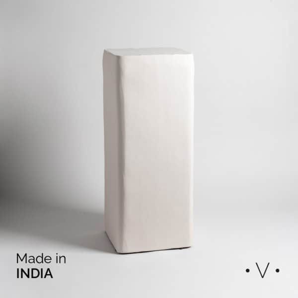 A tall, rectangular display pedestal with an off-white, textured finish. The edges appear subtly rou… — 3D model