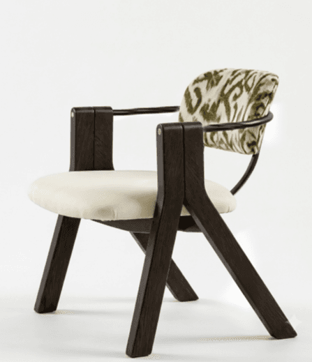 A contemporary armchair featuring a dark brown wooden frame, a cream upholstered seat cushion, and a distinctive curved backrest with a green and white zebra-like pattern. The arms are integrated into the solid wooden structure, and a black metal rod supports the patterned backrest. — 3D model