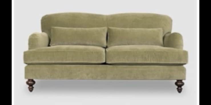 A traditional two-seater loveseat upholstered in a soft, sage green fabric, likely velvet or velour.… — 3D model
