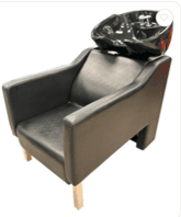 A black upholstered chair with an integrated glossy black ceramic shampoo bowl and chrome faucets, designed for hair washing in a salon setting. — 3D model