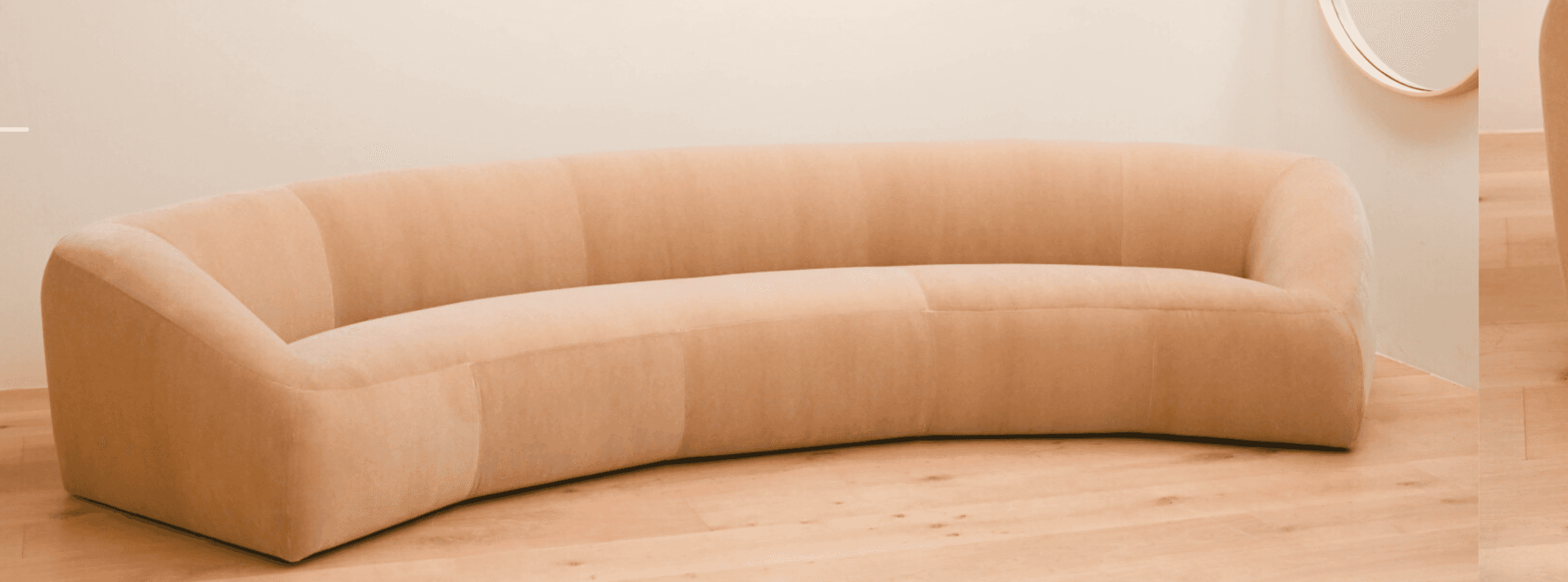 A contemporary, generously curved upholstered sofa in a light, neutral beige tone. The sofa features… — 3D model