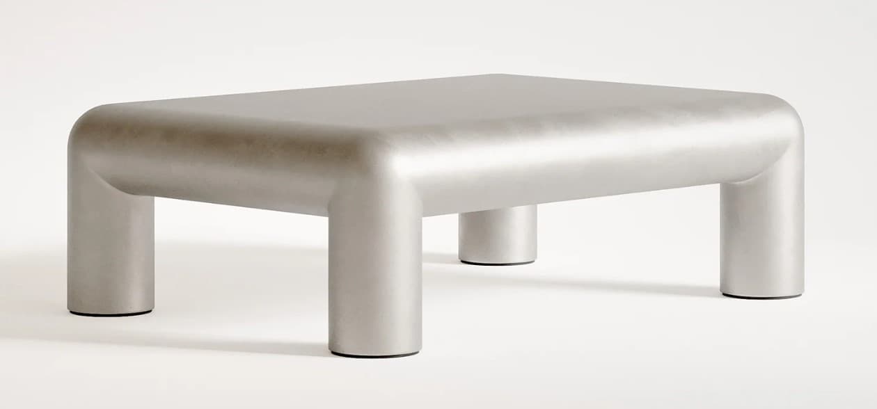 A contemporary coffee table with a monolithic design. It features a rectangular top with rounded edges that seamlessly transitions into four cylindrical legs. The overall form is smooth and sculptural, suggesting a modern aesthetic. — 3D model