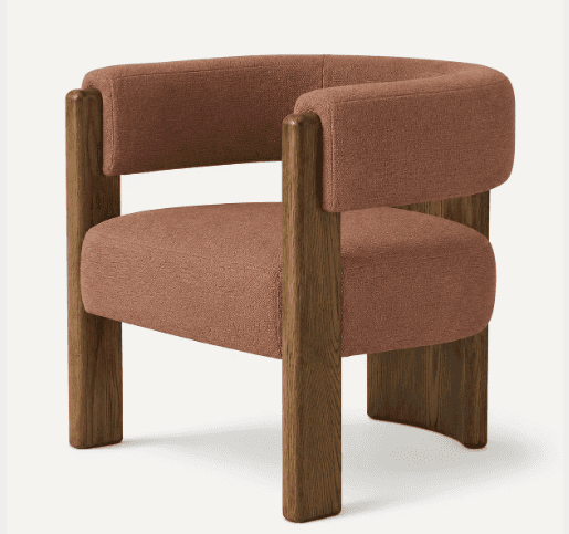 A contemporary armchair featuring an exposed dark-stained wooden frame and terracotta-colored textured fabric upholstery. The chair has a rounded, continuous backrest and armrests, and a generously padded seat, all supported by chunky, rectilinear wooden legs. — 3D model