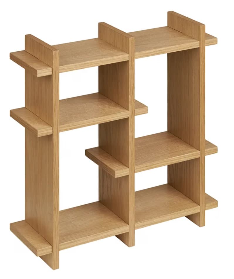 A light wood shelving unit featuring an open-back design and an asymmetric arrangement of shelves and vertical dividers. The construction appears to be interlocking panels, creating multiple compartments of varying sizes. The wood grain is visible, suggesting a natural wood or veneer finish. The unit is designed for display or storage, suitable for a modern interior. — 3D model