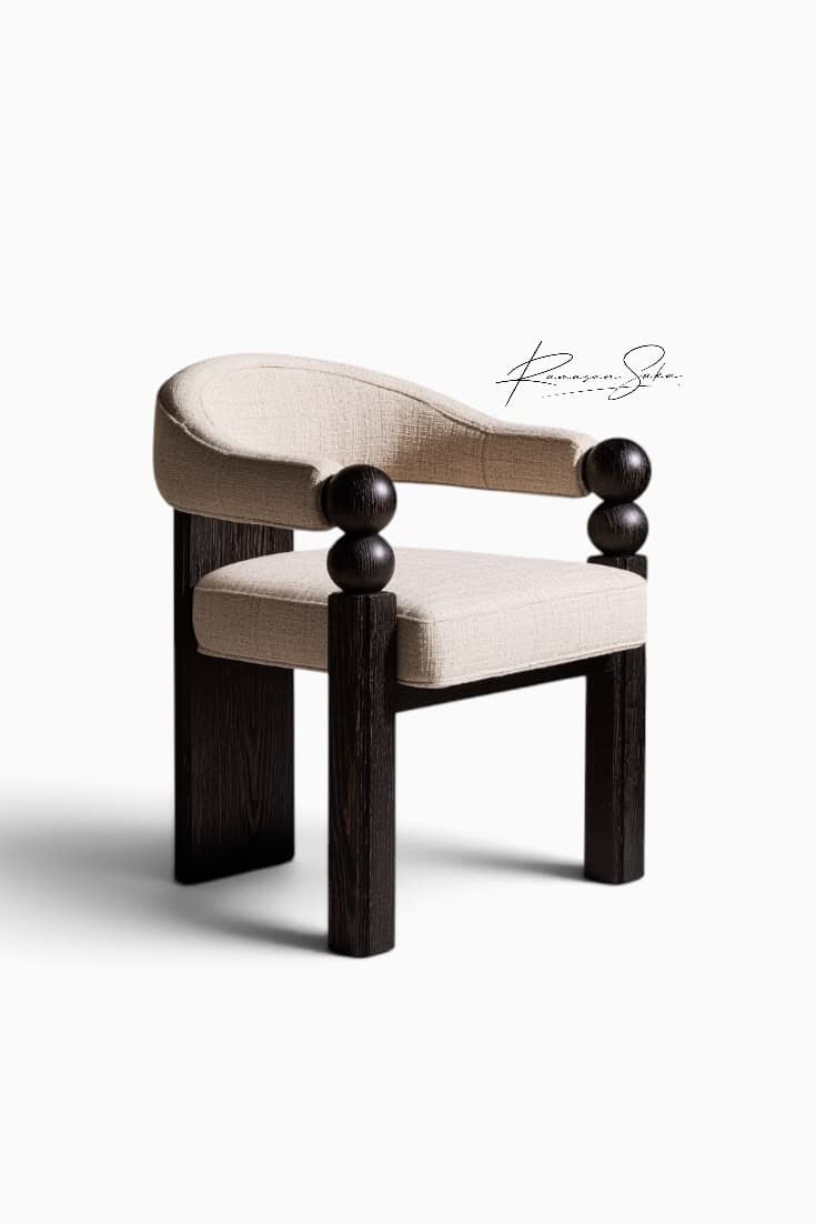 A contemporary armchair featuring a light-colored, textured upholstered seat and a curved backrest that flows into integrated armrests. The frame consists of dark, possibly ebonized, wooden block legs and prominent spherical wooden elements that form part of the armrest supports. The design is modern with sculptural details. — 3D model