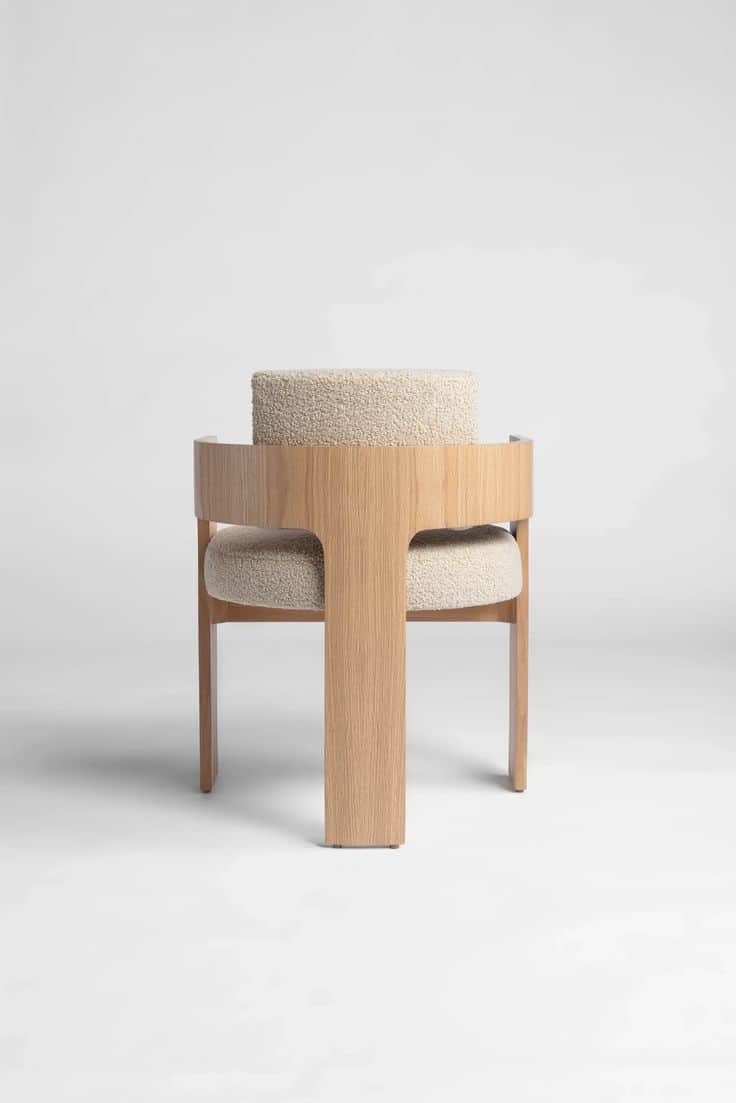 A modern accent chair featuring a distinctive T-shaped oak wood frame and integrated curved backrest… — 3D model