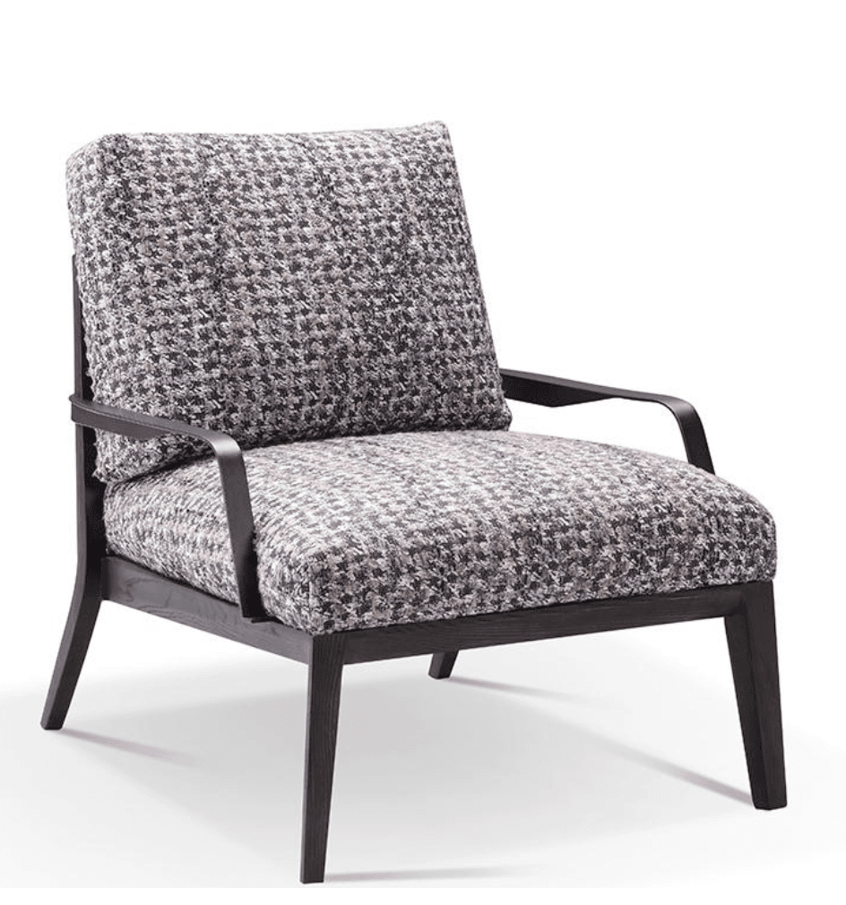 An upholstered lounge armchair featuring a dark brown stained wooden frame, plump seat and back cushions, and slender black metal armrests. The cushions are covered in a textured, multi-tonal woven fabric with a small, houndstooth-like pattern in shades of grey, brown, and off-white. The wooden frame has clean lines with tapered front legs and slightly splayed rear legs, supporting the deep seat and a subtly reclined back. — 3D model