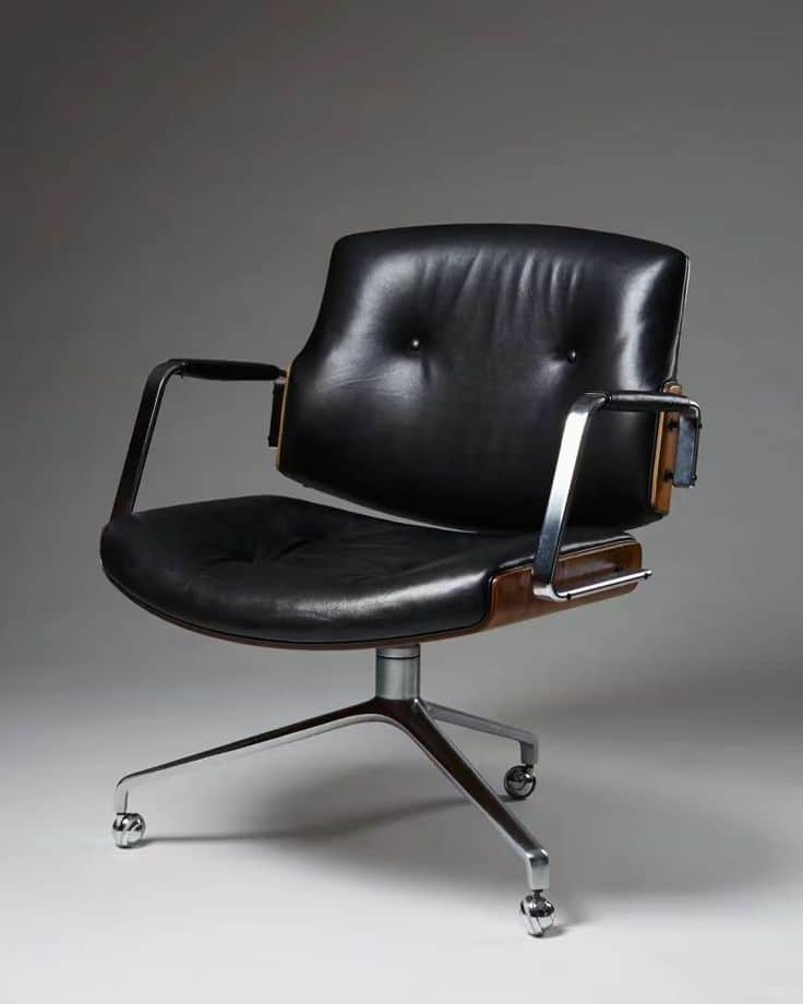 An executive-style swivel chair featuring black leather upholstery, a curved wooden shell, and a pol… — 3D model