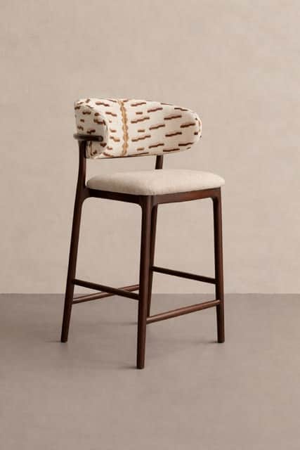 A bar stool featuring a dark wood frame with a light-colored upholstered seat and a distinctively pa… — 3D model