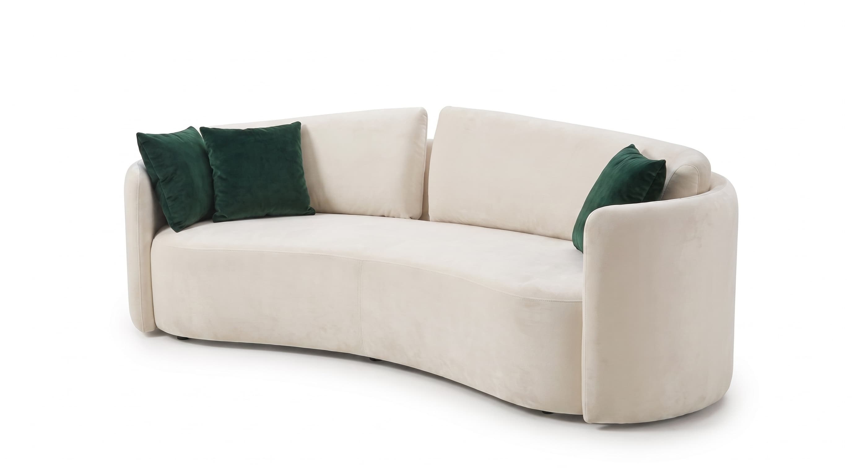A contemporary curved sofa upholstered in a cream-colored velvet fabric, featuring a distinctive crescent shape and a low-profile design. It includes loose back cushions and is accessorized with dark green velvet throw pillows. — 3D model