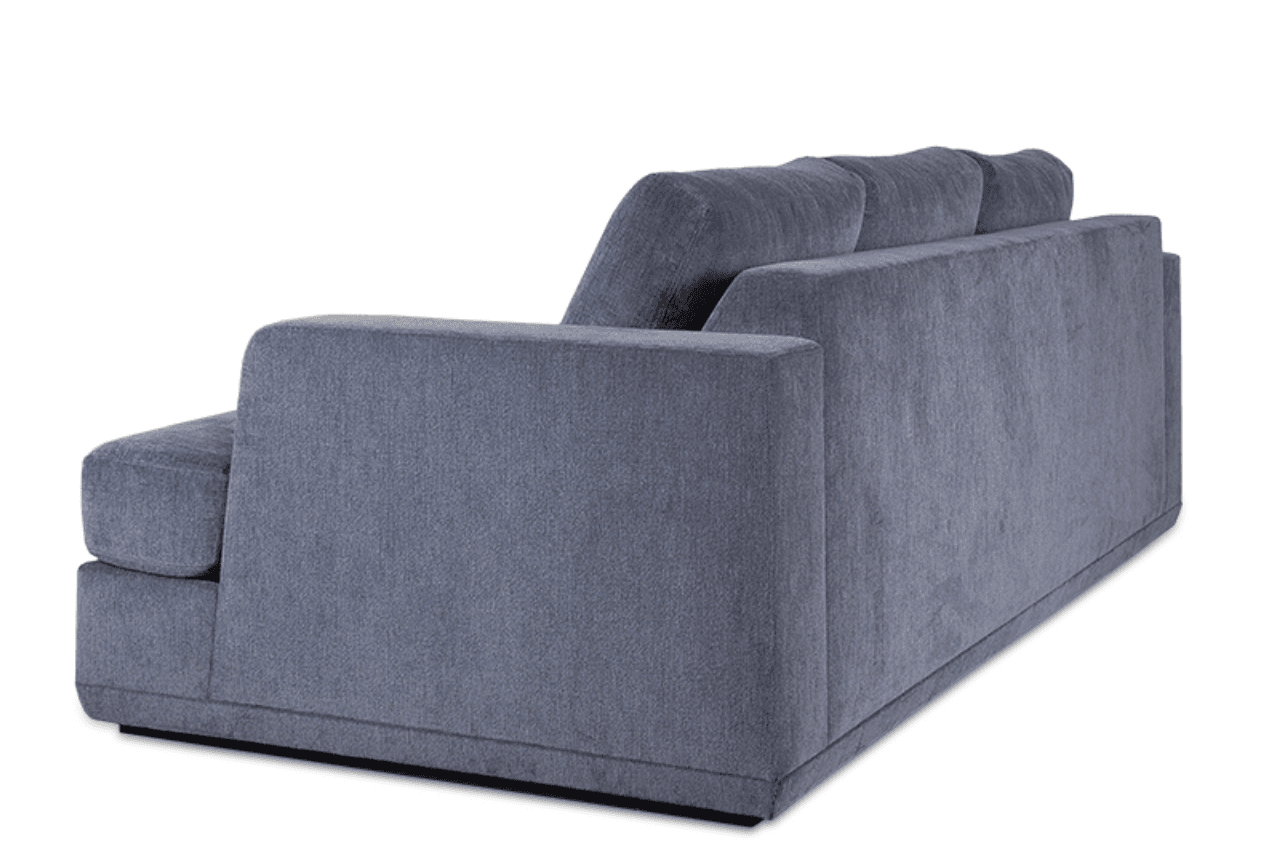 A contemporary upholstered sofa, viewed from the rear-right angle, featuring clean lines and a substantial form. It is covered in a textured slate gray fabric, presenting a modern aesthetic. The design includes thick, squared-off track arms and loose, plush back cushions. The sofa sits on a recessed plinth base, giving it a slightly floating appearance. The overall condition appears new and well-maintained. — 3D model