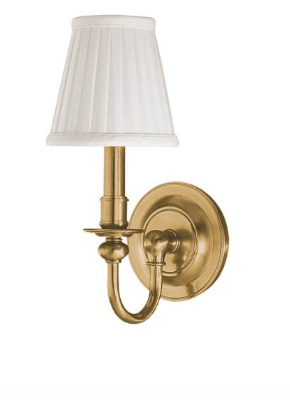 A brass wall sconce featuring a pleated white fabric lampshade. The sconce arm curves downwards from… — 3D model