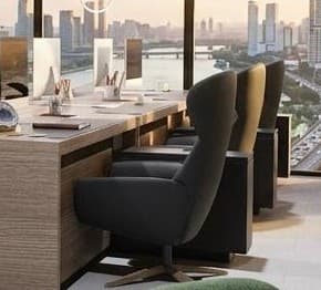 A modern armchair with a high, curved backrest and a plush seat. It features a swivel base with four splayed legs. — 3D model