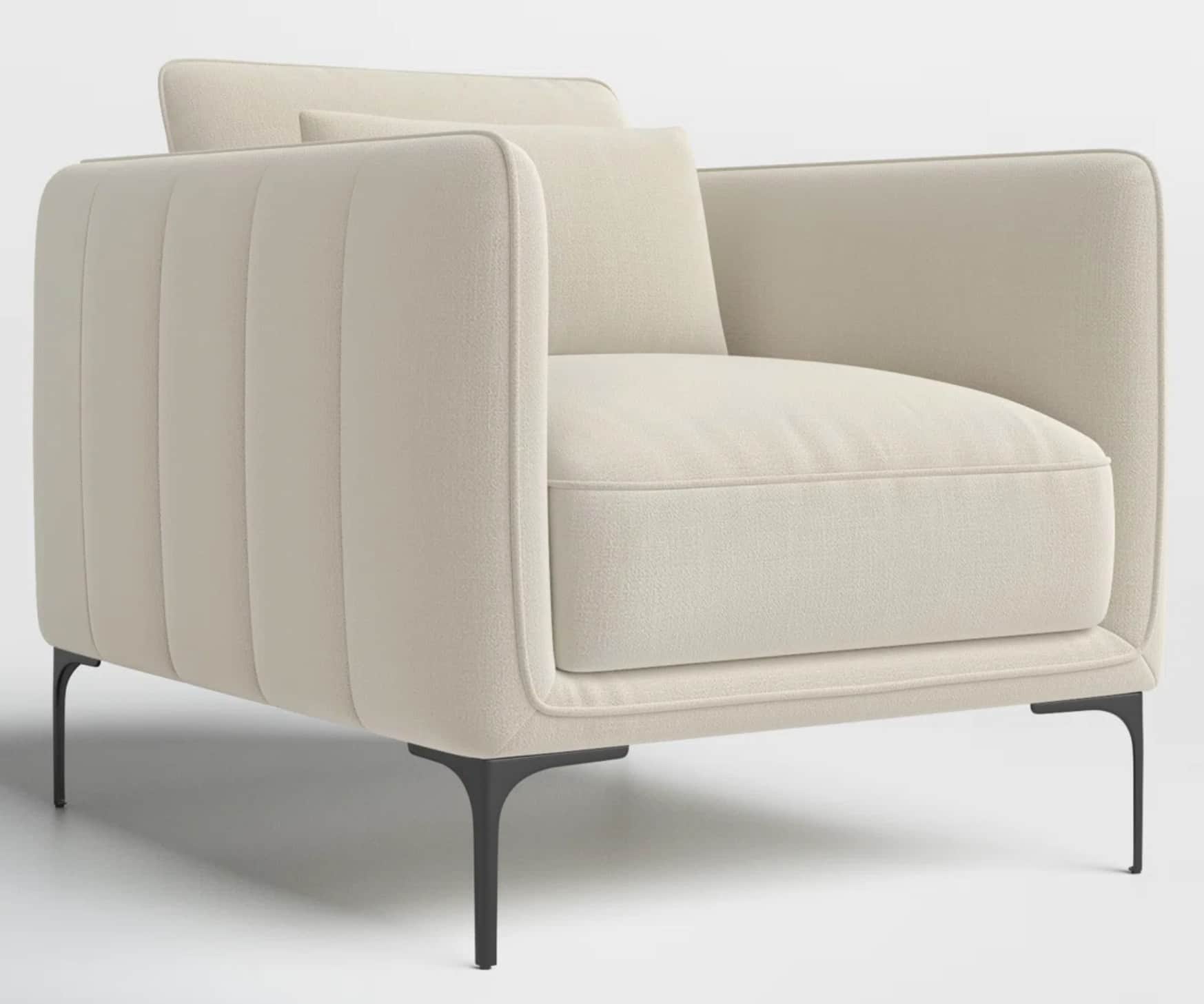A modern upholstered armchair featuring channel tufting on the outer back and arms, light-colored fa… — 3D model