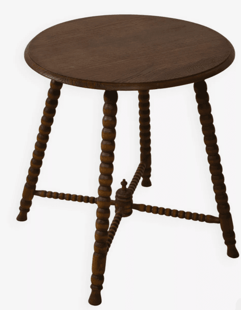 A small, round-topped side table with turned spindle legs. The legs are decorative, featuring a bobbin-turned design. A stretcher connects the legs near the bottom, adding stability. The top has a slightly beveled edge. — 3D model